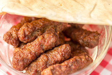 traditional romanian sausages called ”mici” or ”mititei” (dish consisting of grilled ground meat rolls in cylindrical shape made from a mixture of meat and spices)