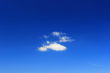 Naklejka na ściany i meble Small clouds on clear blue sky
