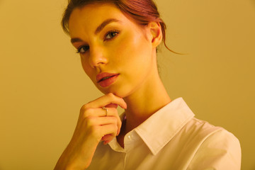 Image of serious successful woman posing and looking at camera