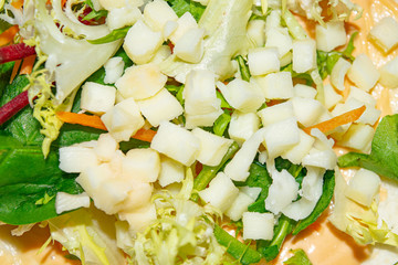 Leafy salad, sliced vegetables and pita sauce are the basis for homemade Shawarma. Close up.