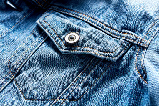 Vintage denim or blue jeans jacket pocket and button