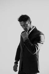 Portrait of handsome stylish man in jacket and watch on white background