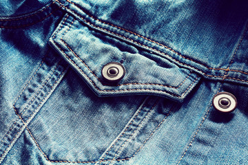 Vintage denim or blue jeans jacket pocket and button