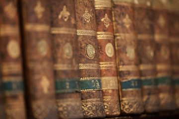 Antique aged books on wooden shelf. Concept on the theme of history, nostalgia, old age.