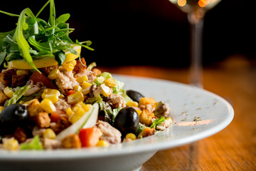 Tun salad with olives, corn and rocket