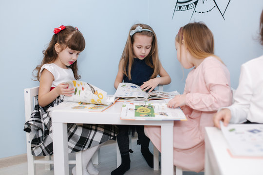 Smart kids learning in prescool class. Female chlidren play in kindergarten