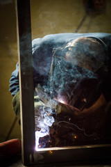 Close up image of a welder working in a manufacturing factory