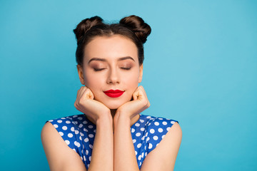 Closeup photo of pretty charming lady red pomade eyes closed hold hands under chin hold face relaxation moment wear dotted white retro blouse shirt isolated blue color background