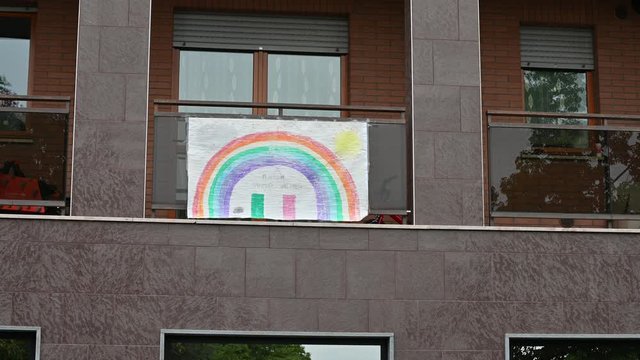 Turin,Piedmont,Italy. May 2020. Coronavirus pandemic. On the facades of the houses hang the sheets with the drawing of the rainbow and the message everything will be fine,in italian "andr&agrave; tutto bene"