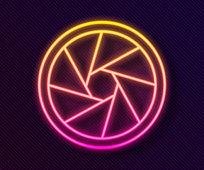 Glowing neon line Camera shutter icon isolated on black background. Vector