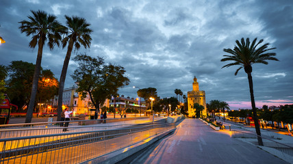 Obraz premium Seville, Spain - February 18th, 2020 - Torre del Oro / Golden Tower and Guadalquivir river in Seville City, Spain.