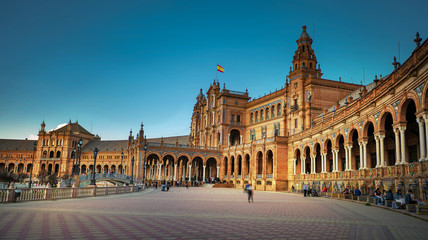 Fototapeta na wymiar Seville, Spain - February 20th, 2020 - The Plaza de España / Spain Square with beautiful view to the Pavilion buildings within the Square in Seville City Center.