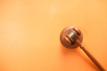 Fototapeta premium top view of gavel on orange background with copy space 