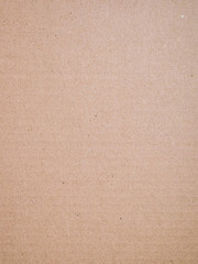 Cardboard surface texture from paper box for packaging. Brown background made from recycled material.