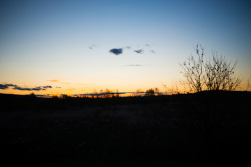 Evening landscape at sunset, warm sunlight over the field, Urals, September