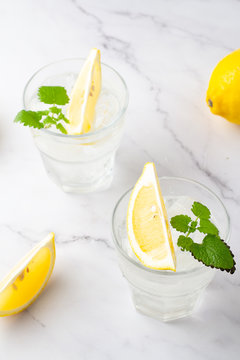 glasses with chilled drink with sld lemon and mint
