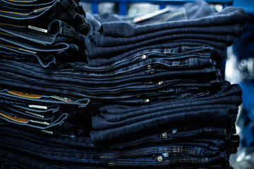 Przemysł odzieżowy, produkcja spodni jeansowych, farbowanie, szycie, pranie, krojenie. - obrazy, fototapety, plakaty