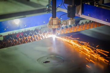 cnc plasma cutting machine cuts metal sheet. Sparks fly