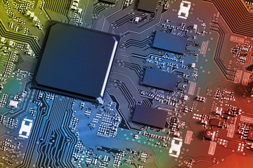 Electronic circuit board with electronic components such as chips close up. Blurry background.	