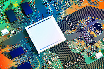 Electronic circuit board with electronic components such as chips close up. Blurry background.	