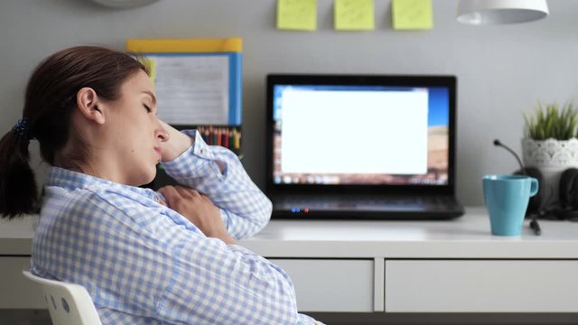 Girl sleeps in workplace. Young woman sits near desk on chair with her eyes closed, she sleeps during day during working hours