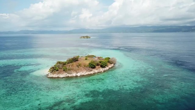 Empty Island - uninhabited island taken with drone, with nice clear sky and sea color. Perfect to fill a gap of your footage