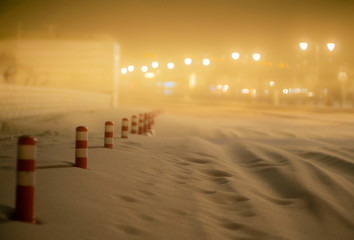Sandstorm at night covering the road with only traffic cones visible