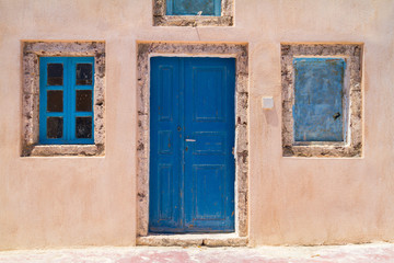 Architecture of Oia town with blue doors on Santorini island, Greece