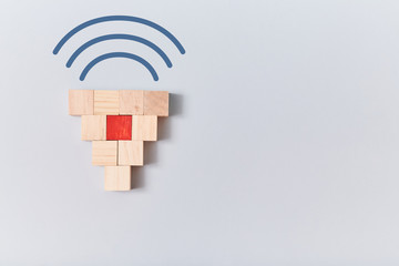 Empty wooden cubes with one red and wifi sign on top. Mockup style, copy space in right side. Isolated on blue backdrop