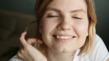Confident shining middle age european woman looking at camera at home iroi. smiling millennial casual female pretty face with blue eyes posing for close up portrait indoors. expressing joy