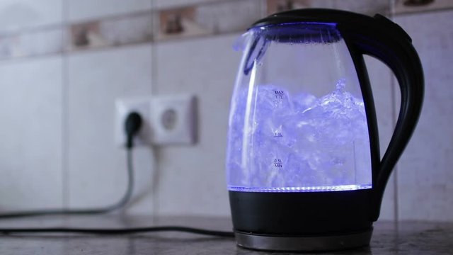 An electric kettle with glass walls. Process of boiling