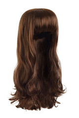 Subject shot of a natural looking brown wig with bangs and wavy strands. The long wig is isolated on the white background. 