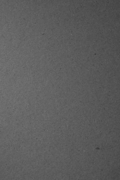 Grey color cardboard. Clean light black paper texture. High resolution vertical photo.