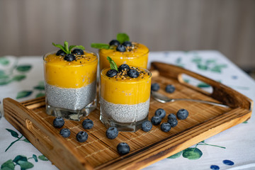 Fresh mango smoothie with blueberries. Healthy diet nutrition. Vegetarian healthy food. Homemade chia pudding. Superfood for strong immunity. Concept of vegetarian breakfast