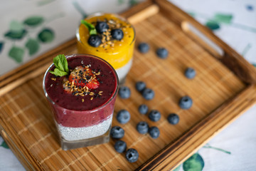Fresh mango smoothie with blueberries. Healthy diet nutrition. Vegetarian healthy food. Homemade chia pudding. Superfood for strong immunity. Concept of vegetarian breakfast