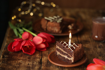 holiday table, quarantined birthday, cake with a candle, chocolate cake. View from above
