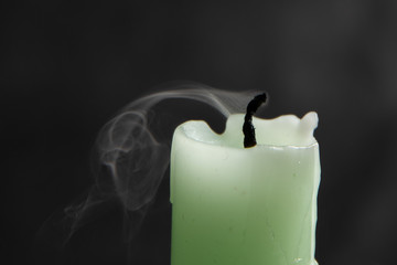 Smoke from an extinguished candle isolated on a black background. Can be used as background. Symbol of sorrow