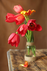 On the table is a vase with a bouquet of flowers. Place for photo.
