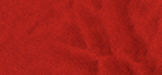 Bright red texture of knit fabric. Red textile background with natural folds. Close-up