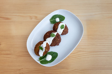 Falafel with yogurt sauce.