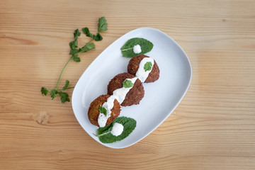 Falafel with yogurt sauce.