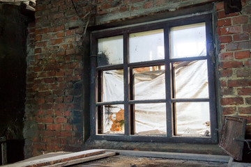 Fototapeta na wymiar Industrial brick building with broken window. Selective focus