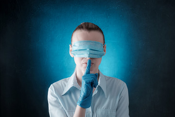 woman with medical face mask, dressed in eyes. concept of conspiracy, deception and misinformation...