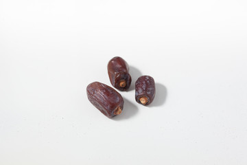 Dried dates fruits on white background, tasted sweet and chewy