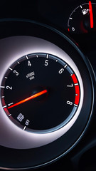 Car instrument cluster with tachometer showing engine idle speed