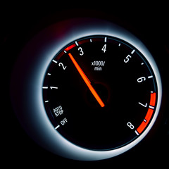 Car instrument cluster with tachometer showing engine idle speed