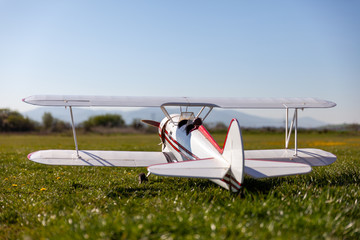 R/C bi-plane with running engine ready to start during summer day © Michal