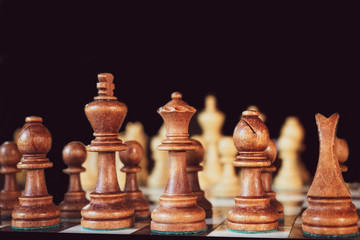 chess pieces on a table on a black background