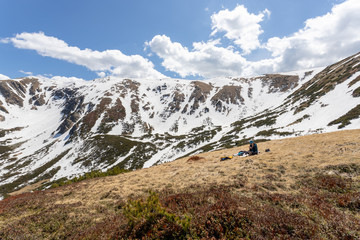 Fototapeta na wymiar Hiker sitting in Low Tatras mountains enjoying sunny spring day