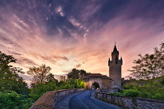 German castle with dramatic clouds at sunrise